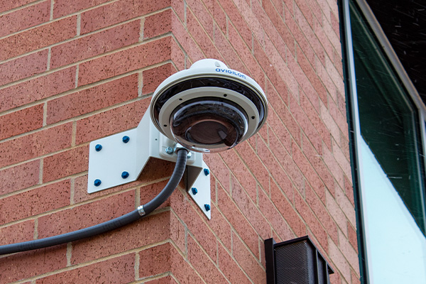 Dome security camera mounted on a brick building exterior